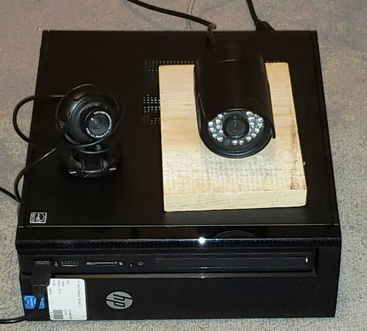 A picture containing indoor, black, sitting, monitor

Description automatically generated